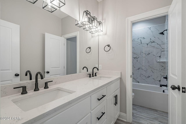 full bathroom with vanity, toilet, and tiled shower / bath