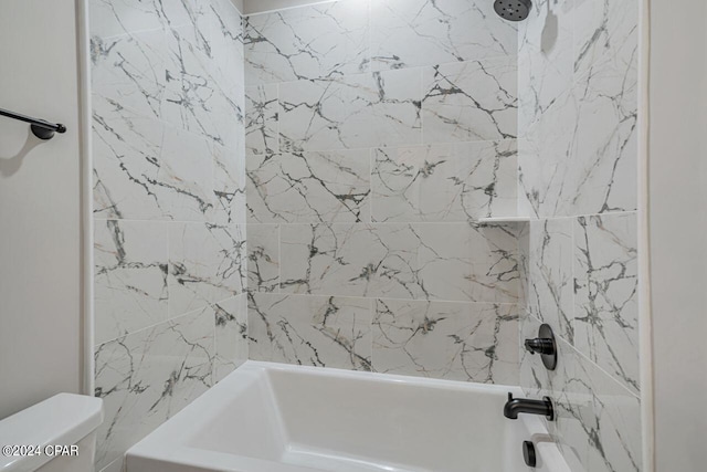 bathroom with toilet and tiled shower / bath combo