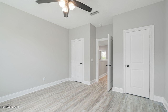 unfurnished bedroom with light hardwood / wood-style floors and ceiling fan