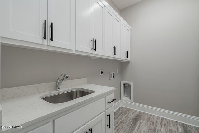 laundry area with sink, cabinets, washer hookup, light hardwood / wood-style floors, and hookup for an electric dryer