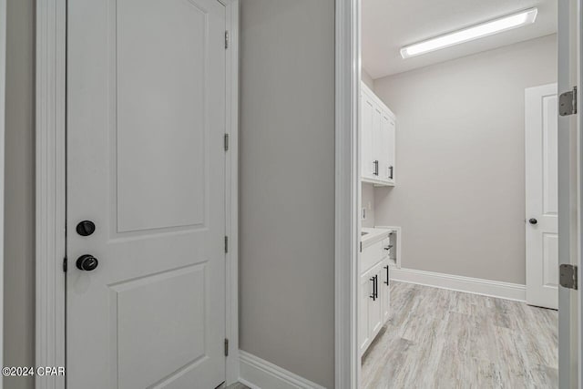 laundry room with light wood-type flooring