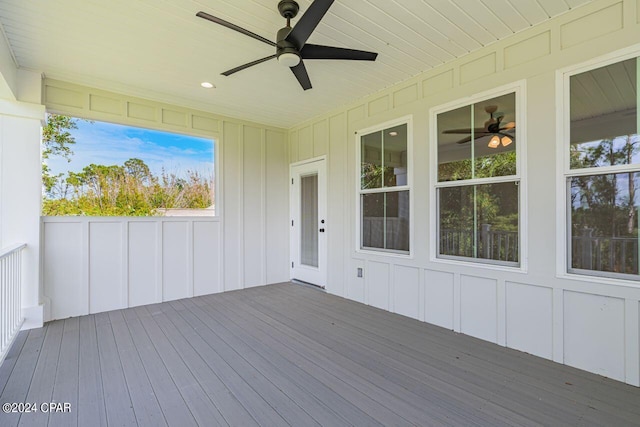 unfurnished sunroom featuring ceiling fan