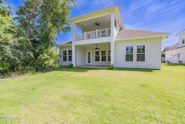 rear view of property with a patio area, ceiling fan, a balcony, and a lawn