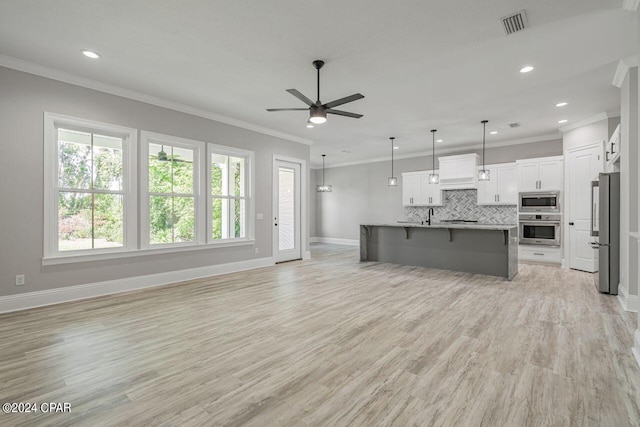 unfurnished living room featuring ceiling fan, ornamental molding, sink, and light hardwood / wood-style floors