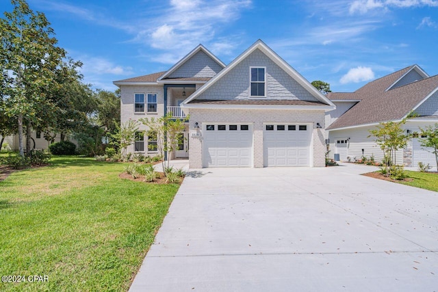 craftsman inspired home with a garage and a front yard