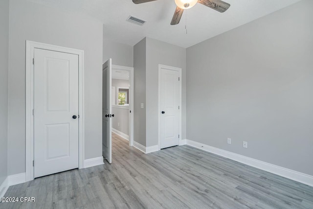 unfurnished bedroom with a textured ceiling, ceiling fan, and hardwood / wood-style floors