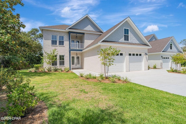 view of front of house featuring a balcony, a garage, and a front lawn