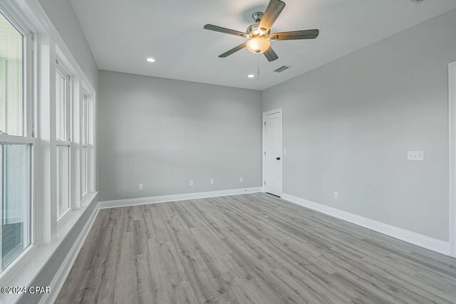 spare room featuring light hardwood / wood-style floors and ceiling fan