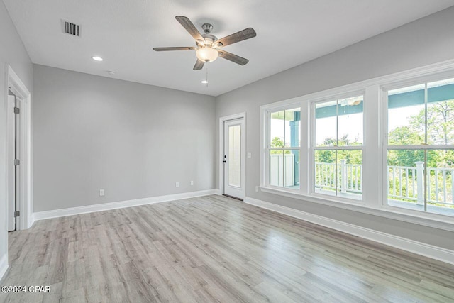 empty room with light hardwood / wood-style flooring and ceiling fan