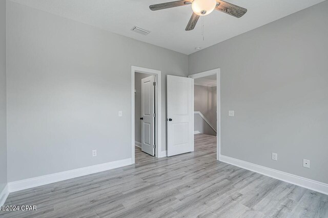 unfurnished room featuring ceiling fan and light hardwood / wood-style floors