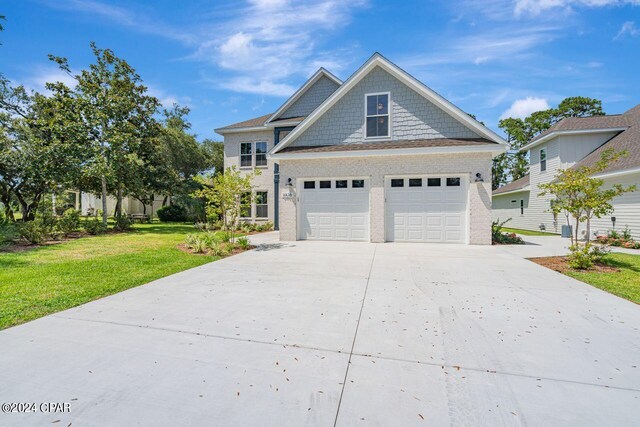 view of front of property featuring a garage and a front lawn