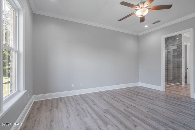 empty room with ornamental molding, hardwood / wood-style floors, and ceiling fan