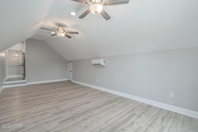 bonus room featuring an AC wall unit, light wood-type flooring, ceiling fan, and lofted ceiling