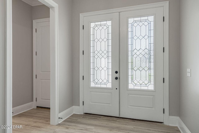 foyer with light hardwood / wood-style flooring and french doors