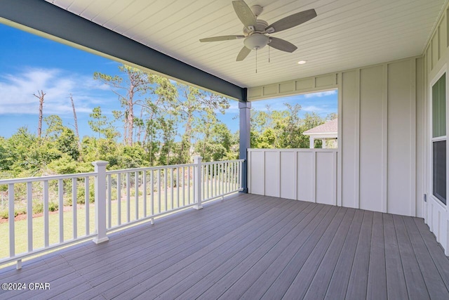 wooden deck featuring ceiling fan