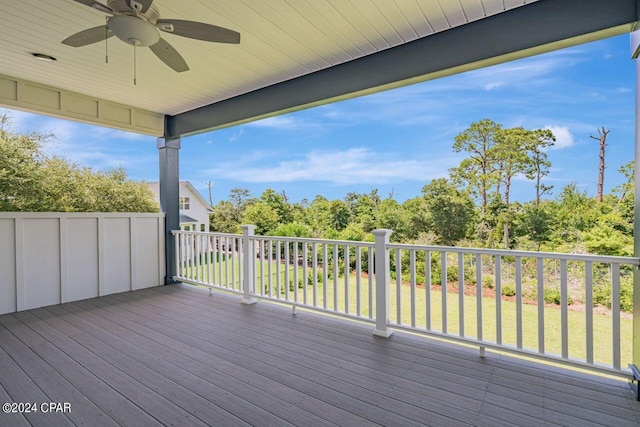 deck featuring a yard and ceiling fan