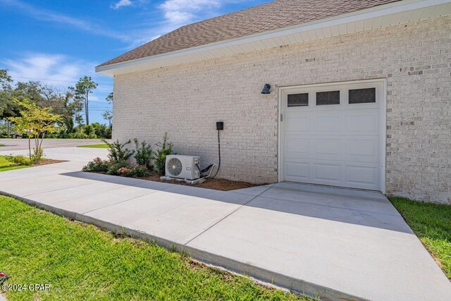 view of property exterior featuring a garage and central AC