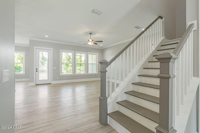 entrance foyer with light hardwood / wood-style floors, ornamental molding, and ceiling fan