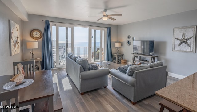 living room with wood-type flooring and ceiling fan