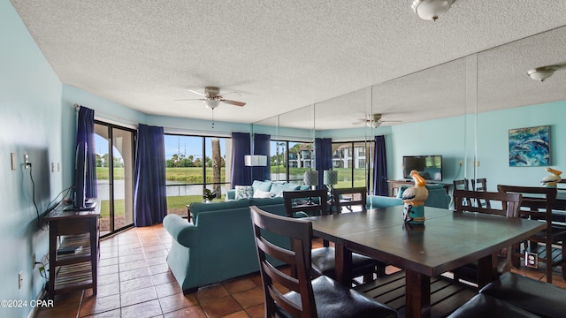 dining space featuring a textured ceiling, tile patterned flooring, and ceiling fan