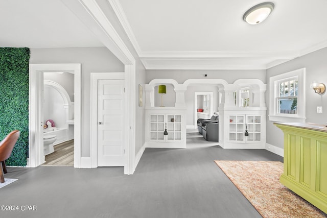 unfurnished bedroom featuring hardwood / wood-style flooring, crown molding, and ensuite bath