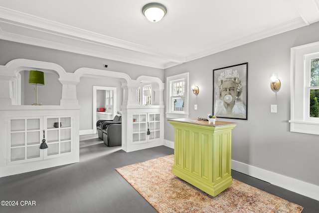 sitting room with crown molding, beamed ceiling, and dark hardwood / wood-style flooring