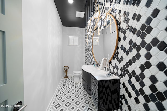 bathroom with tile patterned flooring, toilet, and sink