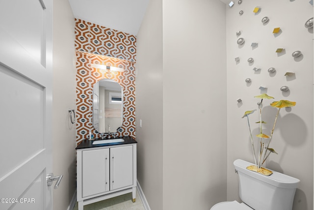 bathroom featuring tile patterned flooring, toilet, and vanity