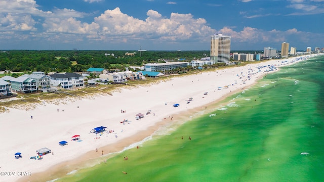 drone / aerial view with a water view and a beach view