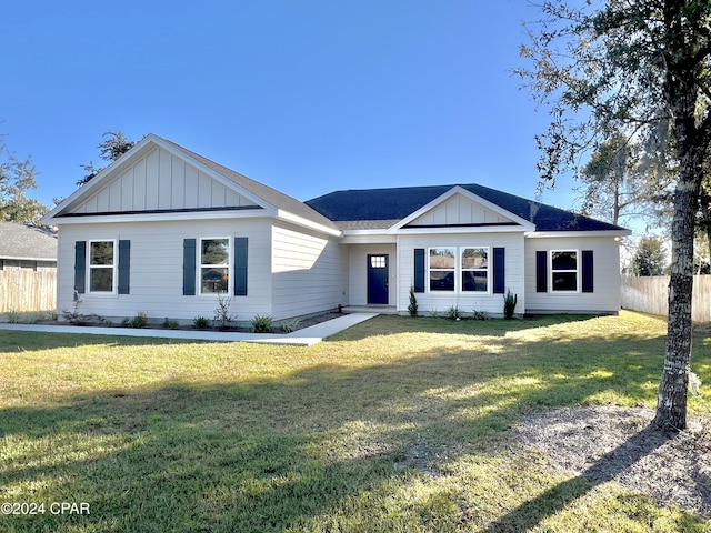 single story home featuring a front lawn