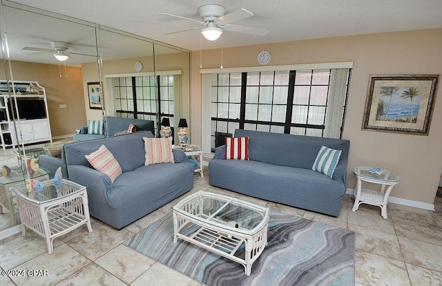 tiled living room featuring ceiling fan