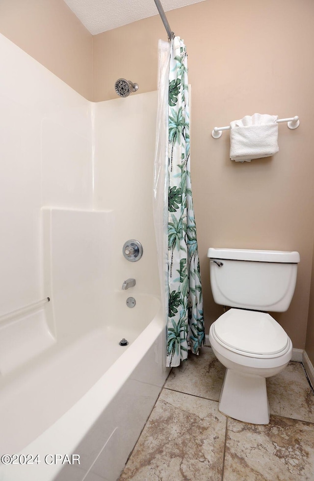 bathroom with shower / bath combination with curtain and toilet