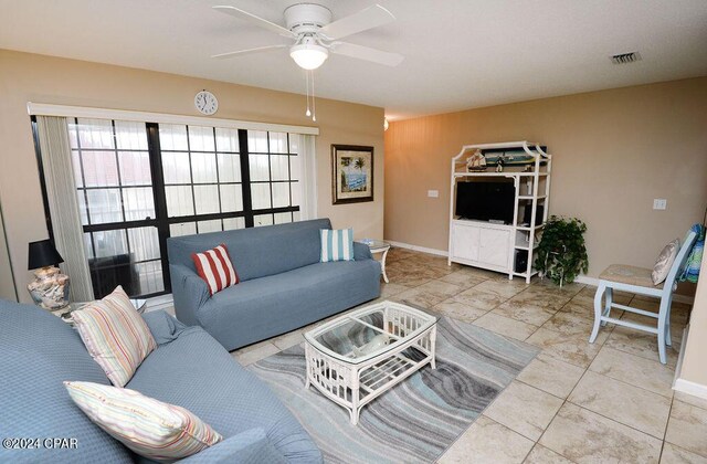 living room featuring light tile patterned floors and ceiling fan