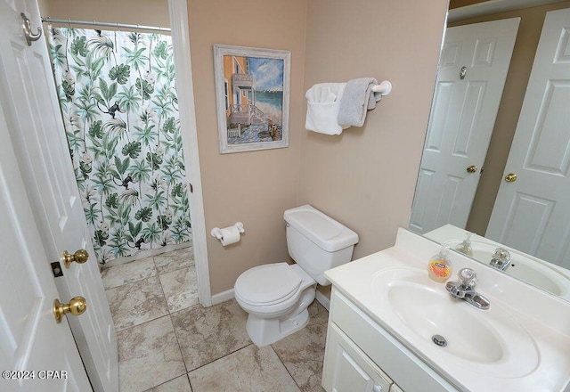 bathroom with vanity, curtained shower, and toilet