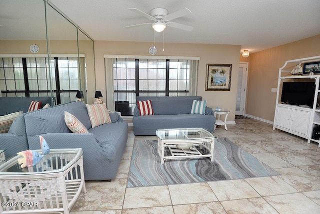 living room featuring ceiling fan and light tile patterned floors