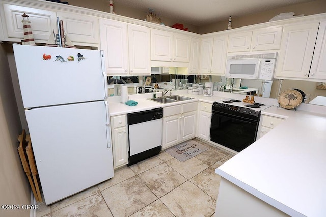 kitchen featuring sink, white appliances, light tile patterned floors, and white cabinets