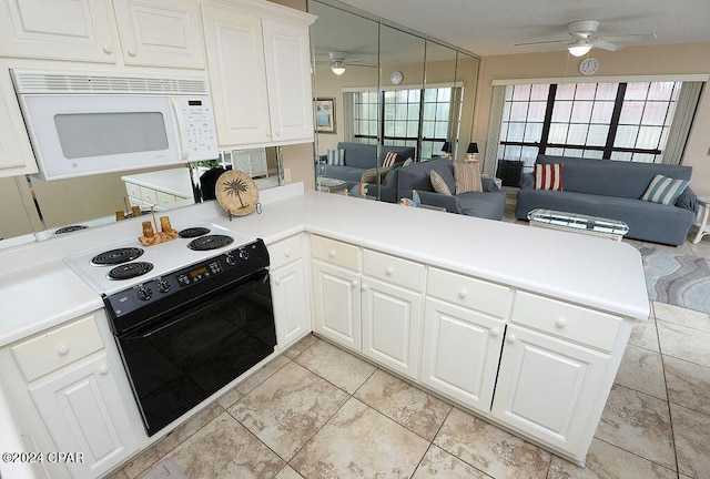 kitchen featuring white cabinetry, electric range, kitchen peninsula, and ceiling fan