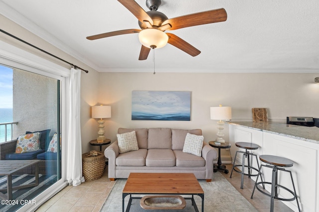 tiled living room with ornamental molding, ceiling fan, and a textured ceiling