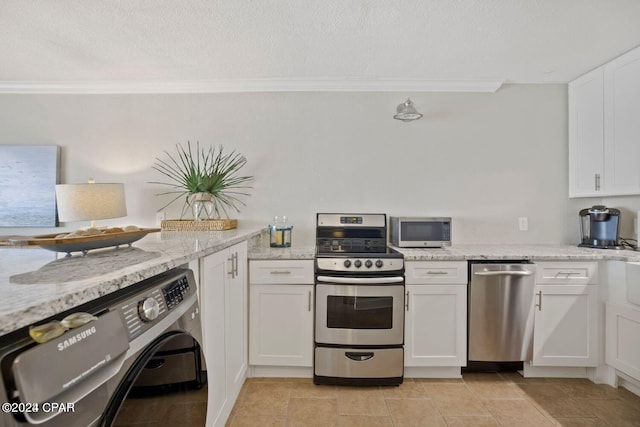 kitchen with washer / clothes dryer, white cabinetry, stainless steel appliances, crown molding, and light stone countertops