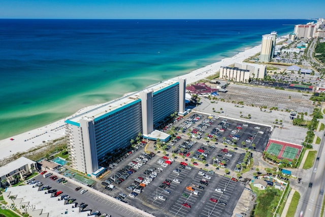 birds eye view of property featuring a beach view and a water view