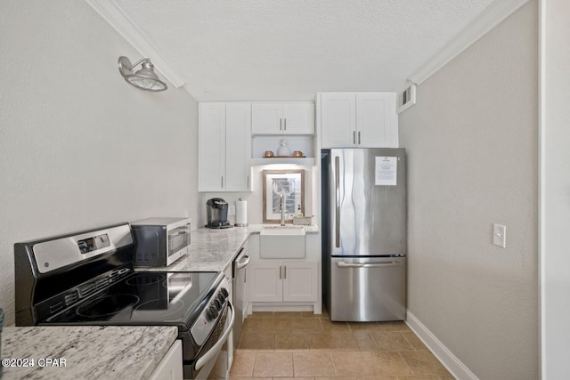 kitchen featuring stainless steel appliances, white cabinetry, a textured ceiling, and sink