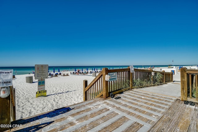 wooden terrace with a water view and a beach view