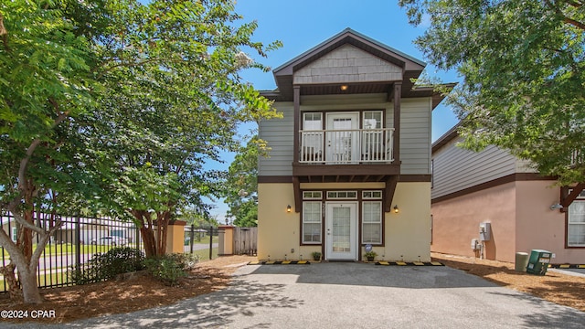 view of front of house featuring a balcony