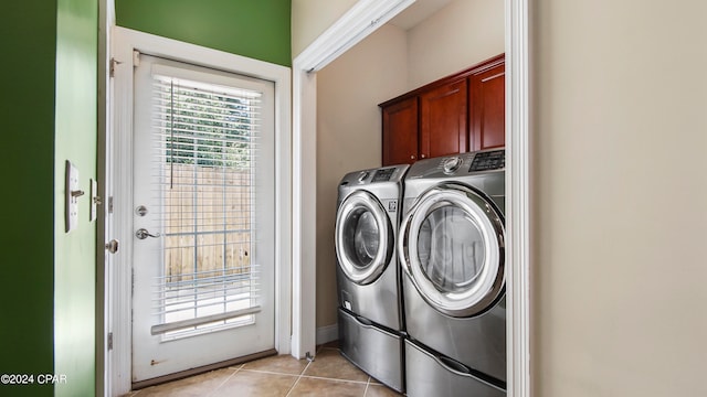 washroom with cabinets, light tile patterned floors, and independent washer and dryer