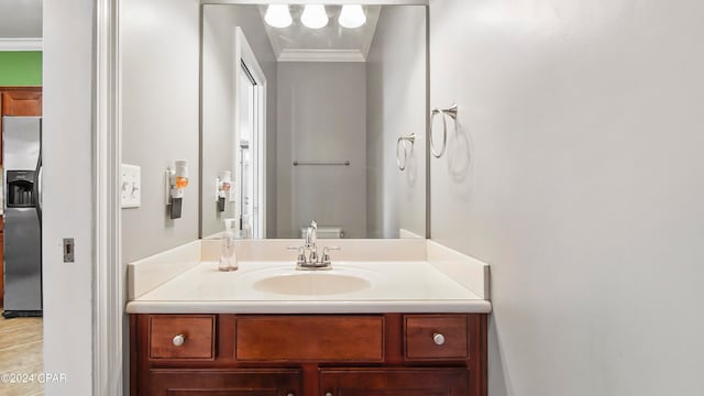 bathroom with vanity and ornamental molding