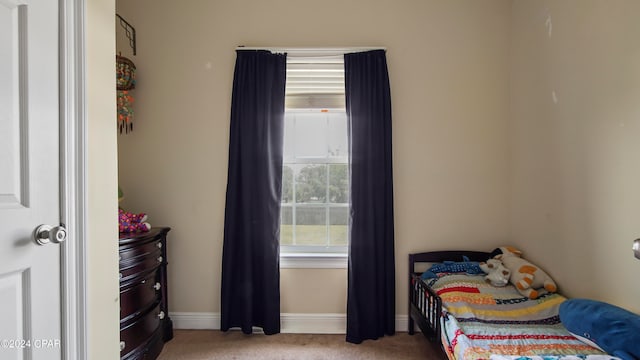 bedroom featuring light carpet