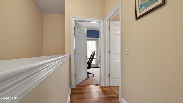 corridor with hardwood / wood-style flooring