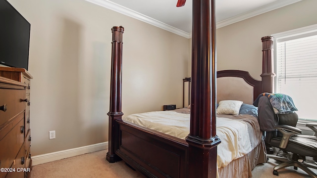 carpeted bedroom featuring ceiling fan and crown molding