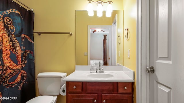 bathroom featuring ceiling fan, toilet, and vanity