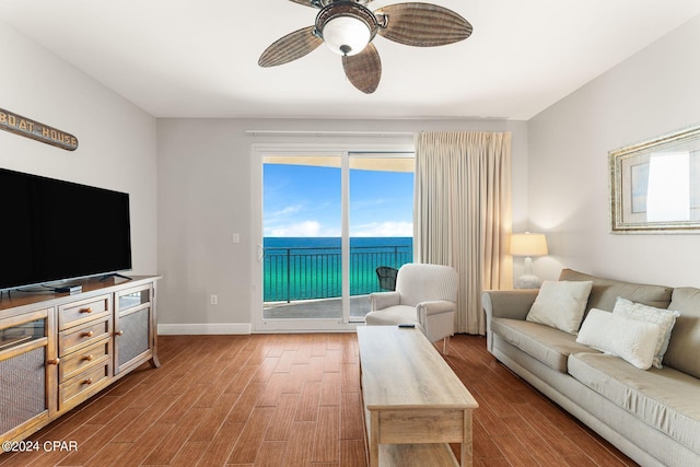 living room featuring ceiling fan and hardwood / wood-style floors